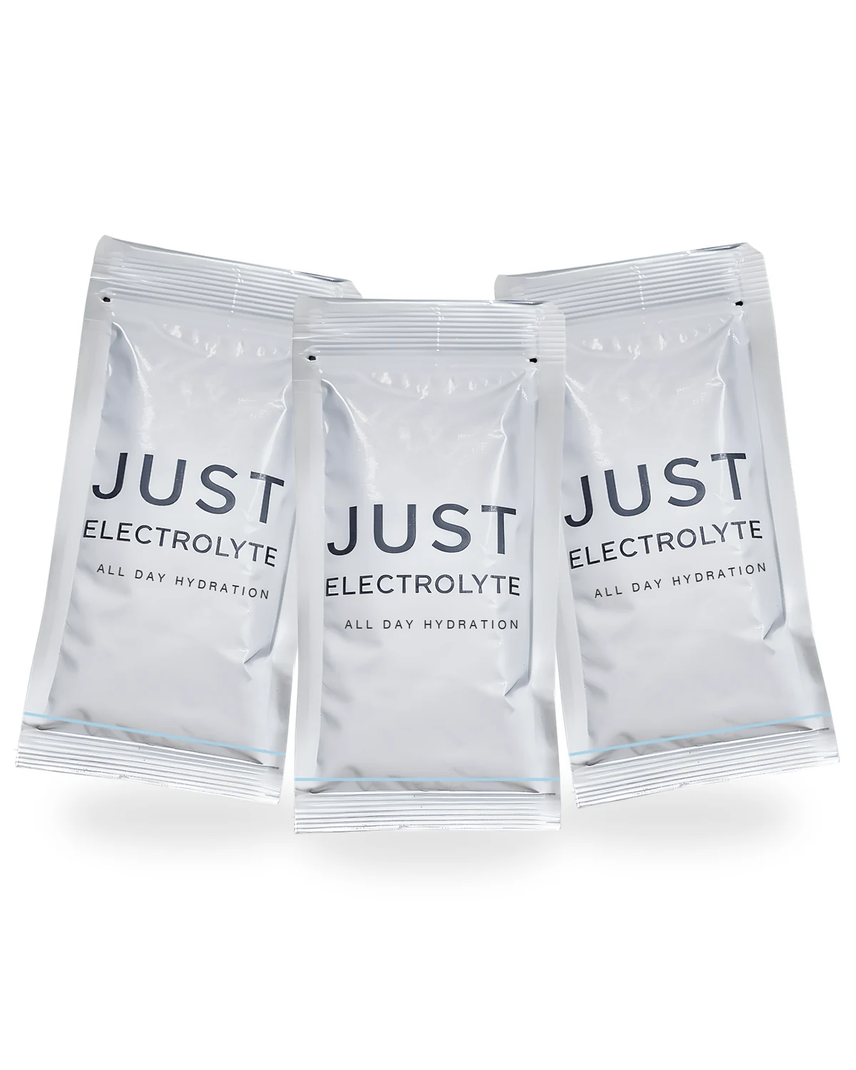 Three white Just Electrolyte single-serve sachets fanned standing, close-up detail with 'JUST ELECTROLYTE' wordmark